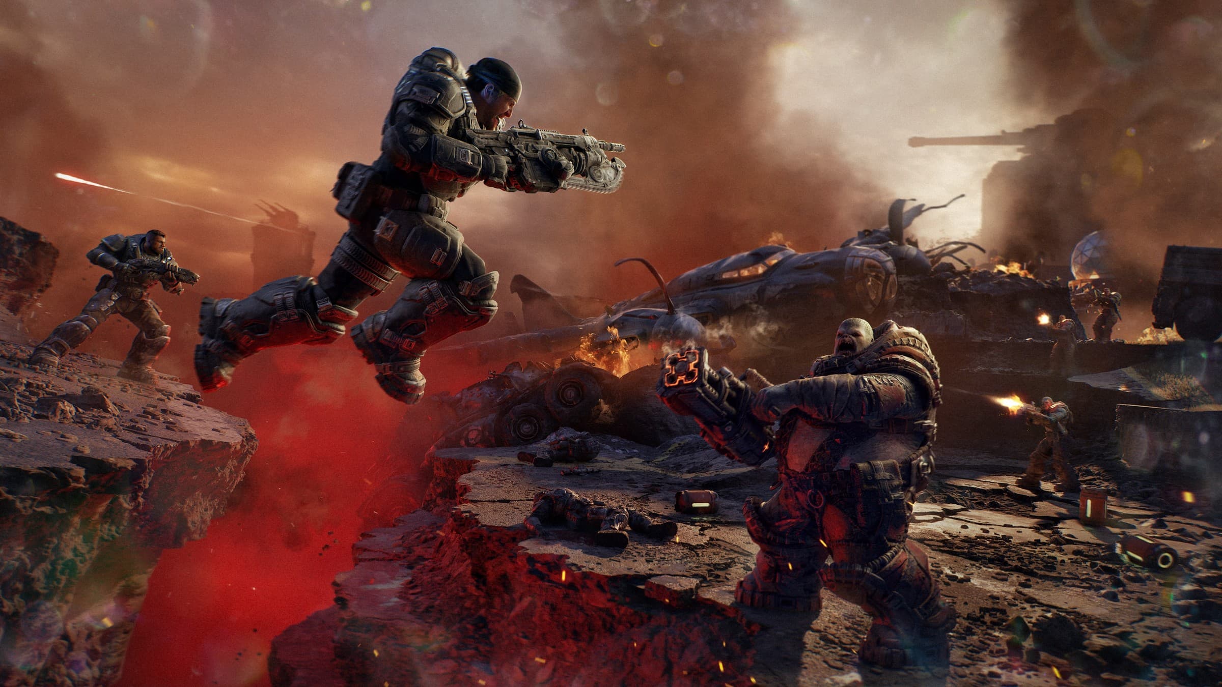Official Gears of War: E-Day screenshot of an armoured soldier leaping across a glowing red chasm with a chainsaw-bayonet rifle while a hulking Locust enemy fires back amid smoke and wreckage