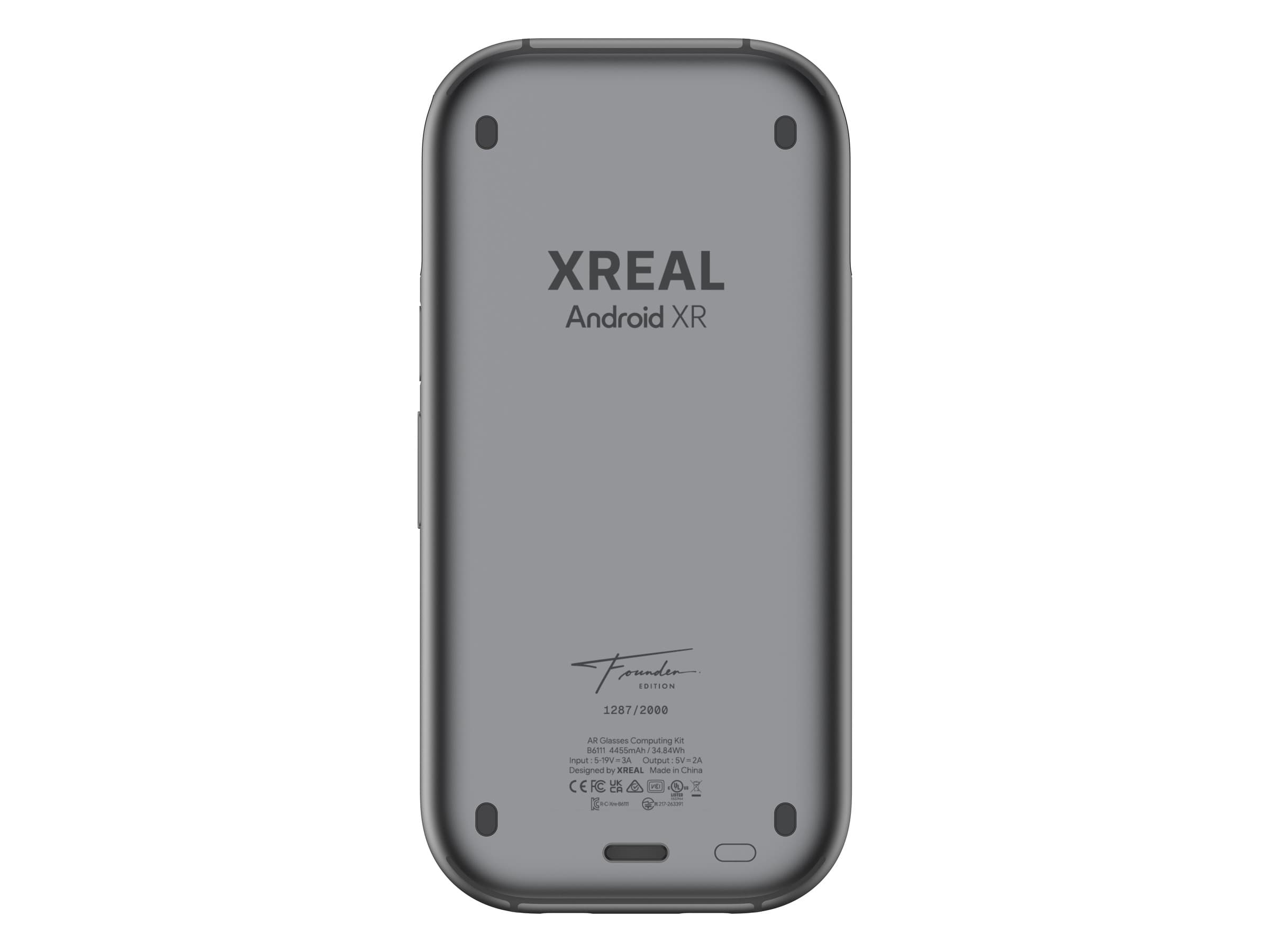 The back of the grey XREAL AURA Founder Edition compute puck, showing the XREAL and Android XR logos, a Founder Edition signature, the number 1287/2000 and small print listing a 4455mAh, 34.84Wh battery