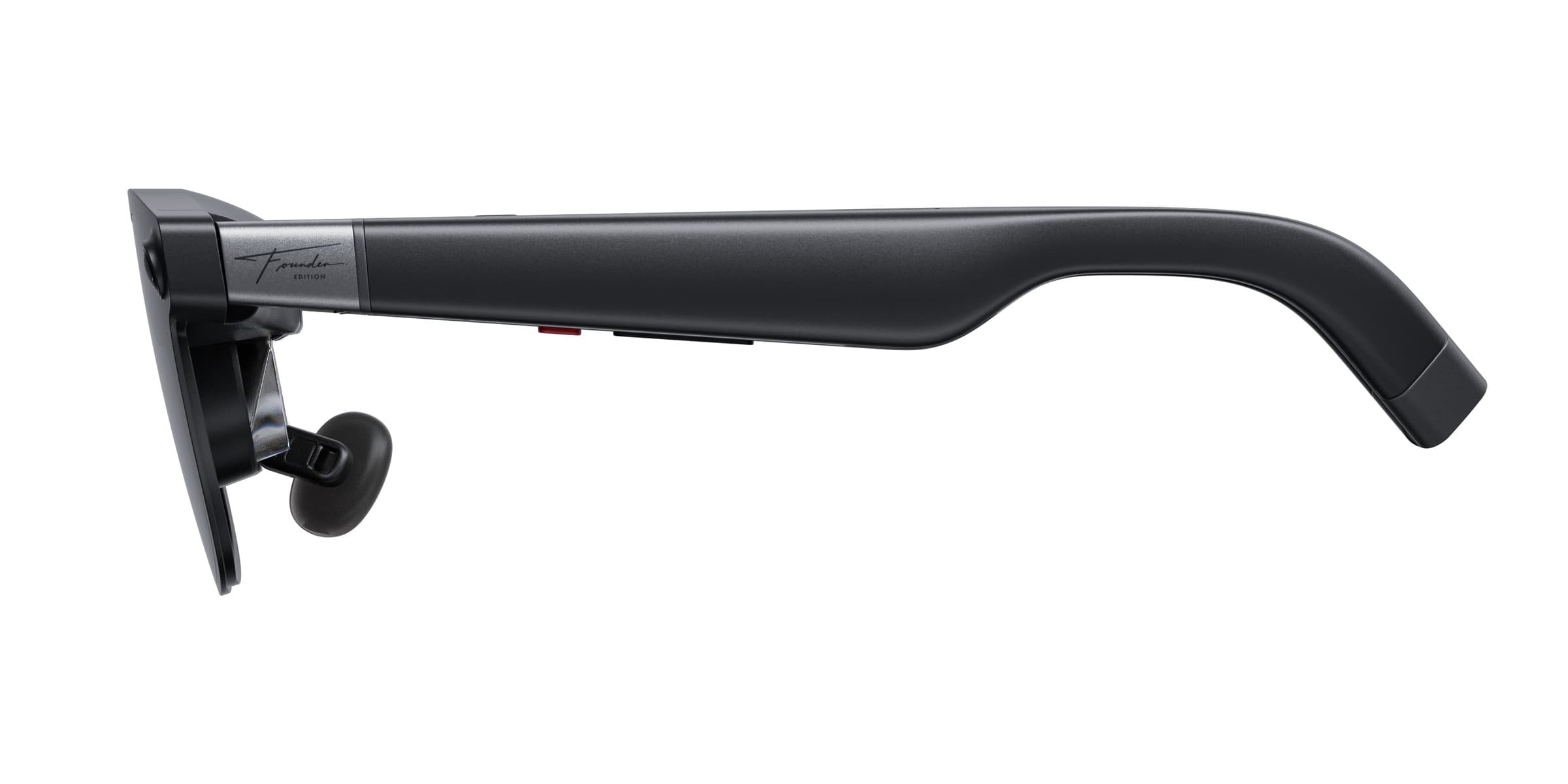 Side view of the black XREAL AURA Founder Edition glasses frame on a white background, with a silver hinge bearing a Founder Edition signature, a small red marker and an adjustable nose pad